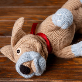 Toy dog. Crochet dog. Hand-knitted toy for children