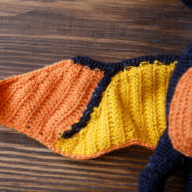 Hand crocheted toy, Orange Pterodactyl, the earliest bird